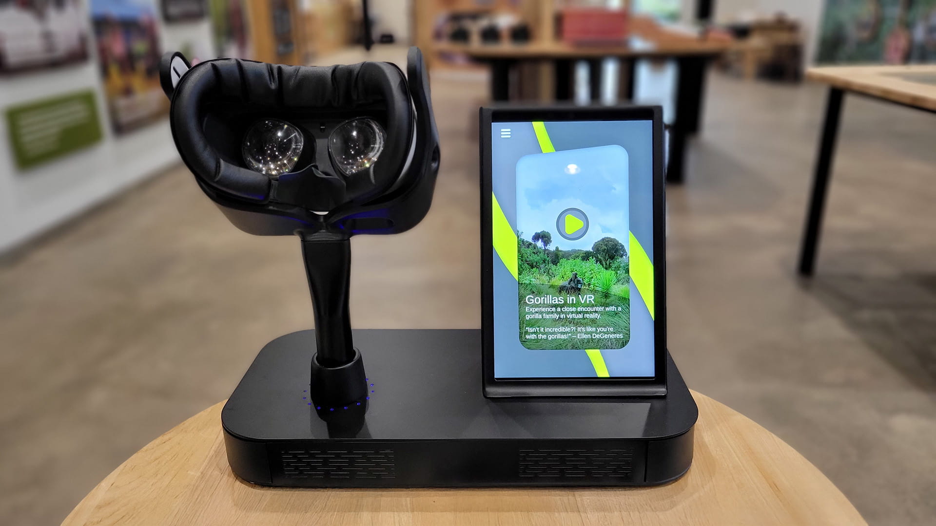 A custom VR hardware setup featuring a mounted headset complete with dock charging, and adjacent touchscreen kiosk used to launch an immersive gorilla experience.
